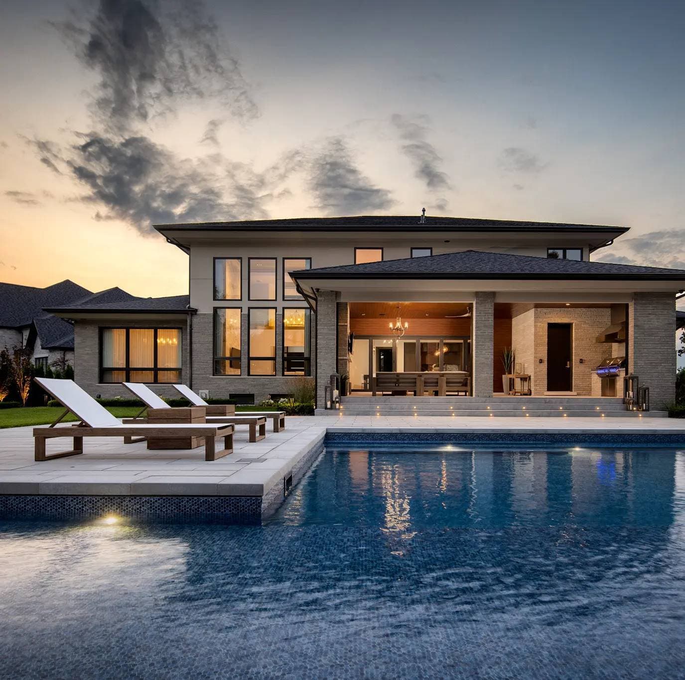 Modern prairie-style custom home at twilight by Timberland Homes