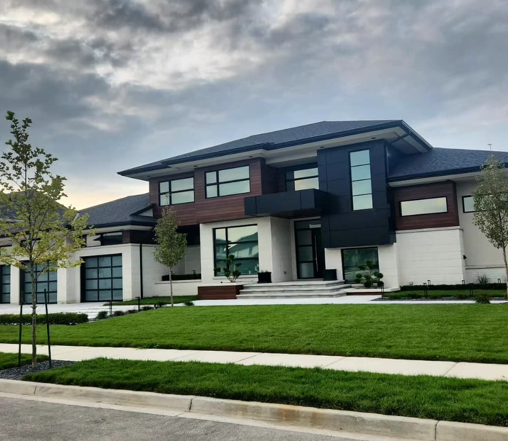 Modern two-story custom home exterior with dark panel accents and stone facade built by Timberland Homes in Tecumseh, Ontario
